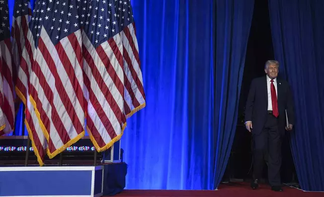 Republican presidential nominee former President Donald Trump arrives at an election night watch party at the Palm Beach Convention Center, Wednesday, Nov. 6, 2024, in West Palm Beach, Fla. (AP Photo/Evan Vucci)