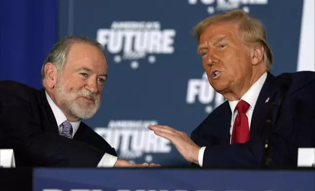 Republican presidential nominee former President Donald Trump talks with former Arkansas Gov. Mike Huckabee during a roundtable at the Drexelbrook Catering &amp; Event Center, Tuesday, Oct. 29, 2024, in Drexel Hill, Pa. (AP Photo/Julia Demaree Nikhinson)