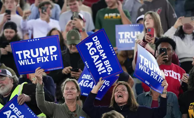 Supporters get ready before Republican presidential nominee former President Donald Trump arrives to speak to a campaign rally at J.S. Dorton Arena, Monday, Nov. 4, 2024, in Raleigh, N.C. (AP Photo/Evan Vucci)