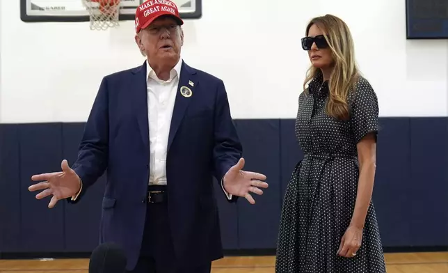 Republican presidential nominee former President Donald Trump speaks as former first lady Melania Trump listens after they voted on Election Day at the Morton and Barbara Mandel Recreation Center, Tuesday, Nov. 5, 2024, in Palm Beach, Fla. (AP Photo/Evan Vucci)