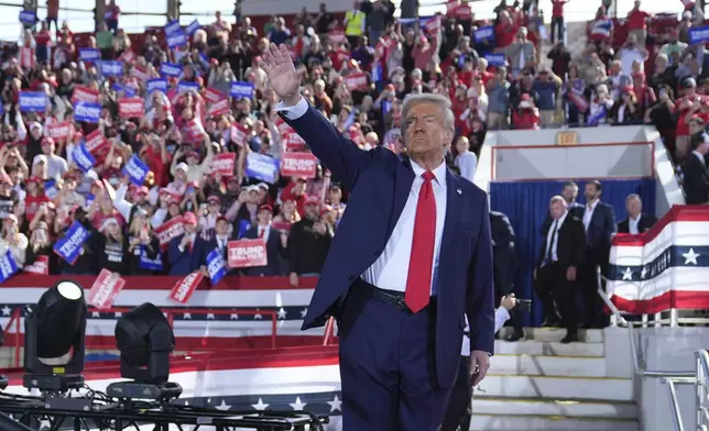 Republican presidential nominee former President Donald Trump waves as he wraps up a campaign rally at J.S. Dorton Arena, Monday, Nov. 4, 2024, in Raleigh, N.C. (AP Photo/Evan Vucci)