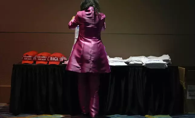 A supporter looks at merchandise for sale ahead of an election night watch party for Republican presidential nominee former President Donald Trump Tuesday, Nov. 5, 2024, in West Palm Beach, Fla. (AP Photo/Julia Demaree Nikhinson)