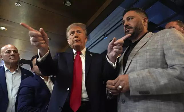 Republican presidential nominee former President Donald Trump talks as owner Albert Abbas, right, listens during a visit to The Great Commoner, Friday, Nov. 1, 2024, in Dearborn, Mich. (AP Photo/Julia Demaree Nikhinson)