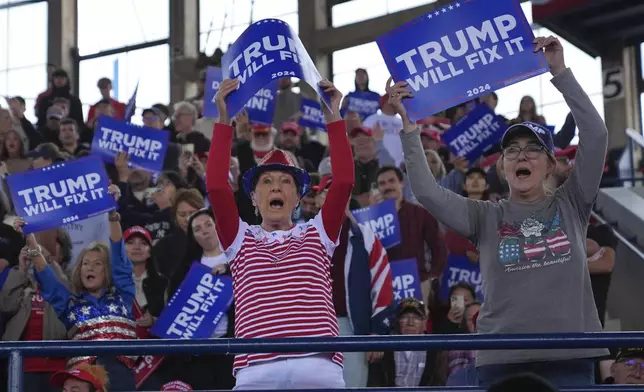 Supporters get ready before Republican presidential nominee former President Donald Trump arrives to speak to a campaign rally at J.S. Dorton Arena, Monday, Nov. 4, 2024, in Raleigh, N.C. (AP Photo/Evan Vucci)