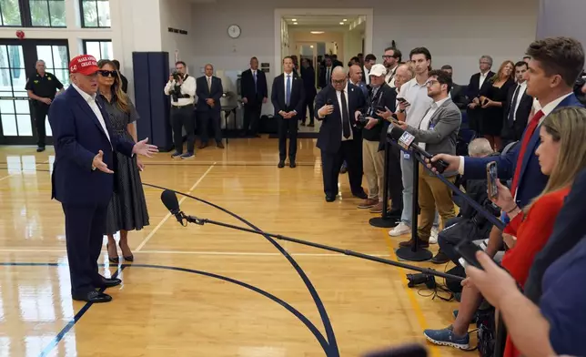 Republican presidential nominee former President Donald Trump speaks as former first lady Melania Trump listens after they voted on Election Day at the Morton and Barbara Mandel Recreation Center, Tuesday, Nov. 5, 2024, in Palm Beach, Fla. (AP Photo/Evan Vucci)