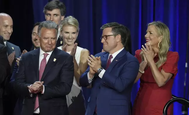 House Speaker Mike Johnson, R-La., and his wife Kelly, right, react as they listen to Republican Presidential nominee former President Donald Trump speaking at the Palm Beach County Convention Center during an election night watch party, Wednesday, Nov. 6, 2024, in West Palm Beach, Fla. (AP Photo/Lynne Sladky)