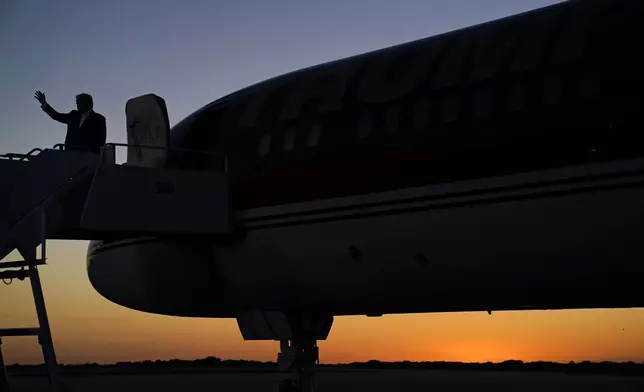 Former President Donald Trump waves before boarding his plane after speaking at a campaign rally at Waco Regional Airport, Saturday, March 25, 2023, in Waco, Texas. (AP Photo/Evan Vucci)