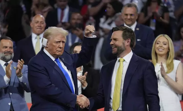 Republican presidential candidate former President Donald Trump is introduced during the Republican National Convention Tuesday, July 16, 2024, in Milwaukee. At right is Republican vice presidential candidate Sen. JD Vance, R-Ohio. (AP Photo/Paul Sancya)