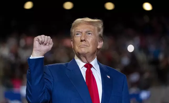 Republican presidential nominee former President Donald Trump pumps his fist as he arrives to speak at a campaign event at Nassau Coliseum, Wednesday, Sept.18, 2024, in Uniondale, N.Y. (AP Photo/Alex Brandon)