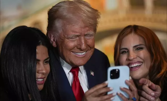 Republican presidential nominee former President Donald Trump poses for a photo at a campaign event at ll Toro E La Capra, Friday, Aug. 23, 2024, in Las Vegas. (AP Photo/Julia Nikhinson)