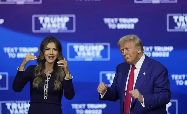 Republican presidential nominee former President Donald Trump and South Dakota Gov. Kristi Noem dance to the song "Y.M.C.A." at a campaign town hall at the Greater Philadelphia Expo Center &amp; Fairgrounds, Monday, Oct. 14, 2024, in Oaks, Pa. (AP Photo/Matt Rourke)