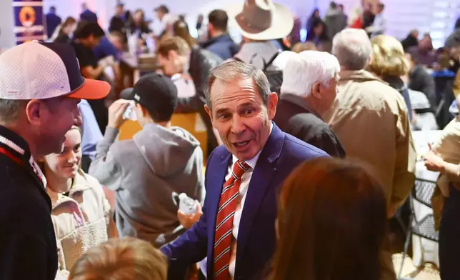 U.S. Rep. John Curtis greets supporters during a election night party Tuesday, Nov. 5, 2024, in Provo, Utah. (AP Photo/Alex Goodlett)