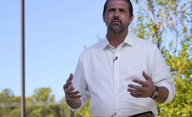 Republican congressional candidate Derrick Anderson gestures during an interview at an early voting station in Stafford, Va., Wednesday, Oct. 23, 2024. Anderson is running against Democrat Eugene Vindman in the 7th Congressional race. (AP Photo/Steve Helber)