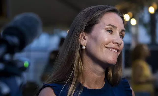 Missy Cotter Smasal speaks to members of the media at Ballyhoos in Virginia Beach, Va., after winning the Democratic nomination in the race to represent the 2nd Congressional District in the U.S. House of Representatives, June 18, 2024. (Kendall Warner/The Virginian-Pilot via AP)