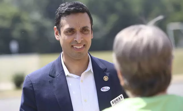 Virginia Sen. Suhas Subramanyam, a Democrat running for Virginia's 10th House seat, talks with voters outside the Harper Park Middle School polling station at in Leesburg, Va., June 18, 2024. (Mark Miller/The Washington Post via AP)