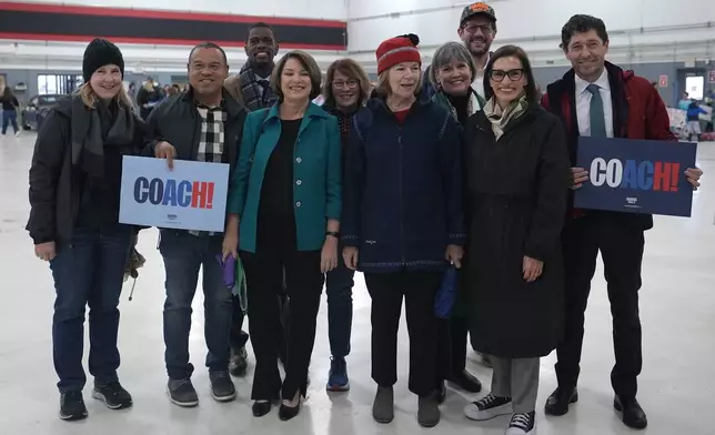 From left, Minnesota House Speaker Melissa Hortman, Minnesota Attorney General Keith Ellison, St. Paul, Minn., Mayor Melvin Carter, Sen. Amy Klobuchar, Minnesota Senate Leader Erin Murphy, Sen. Tina Smith, Rep. Betty McCollum, Minnesota Lt. Gov. Peggy Flanagan and husband Tom Weber, and Minneapolis Mayor Jacob Frey pose for a photo while supporting Democratic vice presidential nominee Minnesota Gov. Tim Walz while departing Minneapolis-St. Paul International Airport, Monday, Nov. 4, 2024, in Minneapolis. (AP Photo/Abbie Parr)