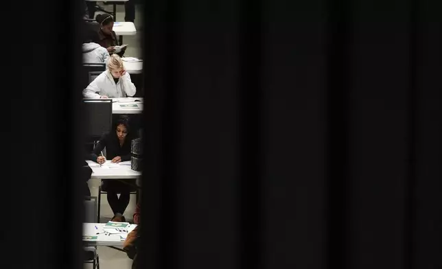 Voters fill out their ballots at a voting center at Lumen Field Event Center on Election Day, Tuesday, Nov. 5, 2024, in Seattle. (AP Photo/Lindsey Wasson)