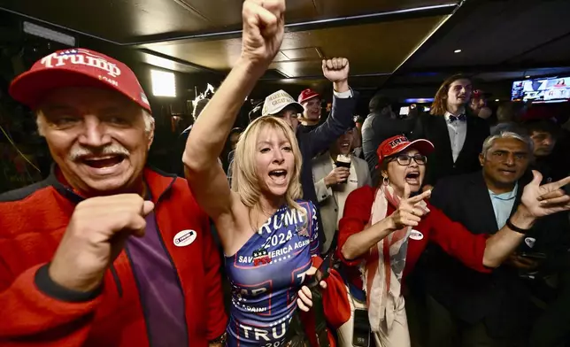 Ed Torres, left, and J. Carrie Torres join others as they celebrate the Republicans retaking the Senate during a GOP election night party at Muldoon's Irish Pub in Newport Beach. Calif., Tuesday, Nov. 4, 2024. (Jeff Gritchen/The Orange County Register via AP)