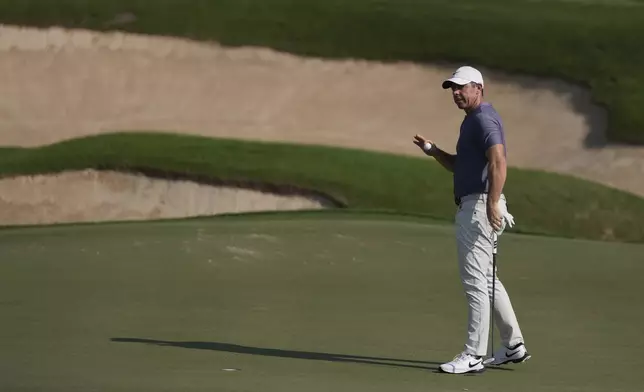 Rory McIlroy of Northern Ireland acknowledges the crowd after he playing his shot at the 12th green during the second round of Abu Dhabi Golf Championship in Abu Dhabi, United Arab Emirates, Friday, Nov. 8, 2024. (AP Photo/Altaf Qadri)