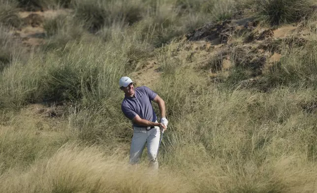 Rory McIlroy of Northern Ireland plays his second shot at the 13th hole during the second round of Abu Dhabi Golf Championship in Abu Dhabi, United Arab Emirates, Friday, Nov. 8, 2024. (AP Photo/Altaf Qadri)