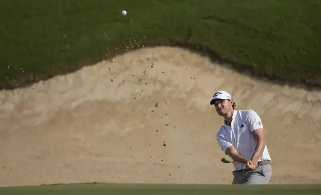 Rasmus Højgaard of Denmark plays his second shot at the 12th hole during the second round of Abu Dhabi Golf Championship in Abu Dhabi, United Arab Emirates, Friday, Nov. 8, 2024. (AP Photo/Altaf Qadri)