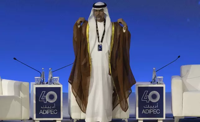 UAE Minister of Energy and Infrastructure Suhail al-Mazrouei arrives on the stage to participate in a panel discussion during the the inaugural session of annual Abu Dhabi International Petroleum Exhibition and Conference (ADIPEC) in Abu Dhabi, United Arab Emirates, Monday, Nov. 4, 2024. (AP Photo/Altaf Qadri)