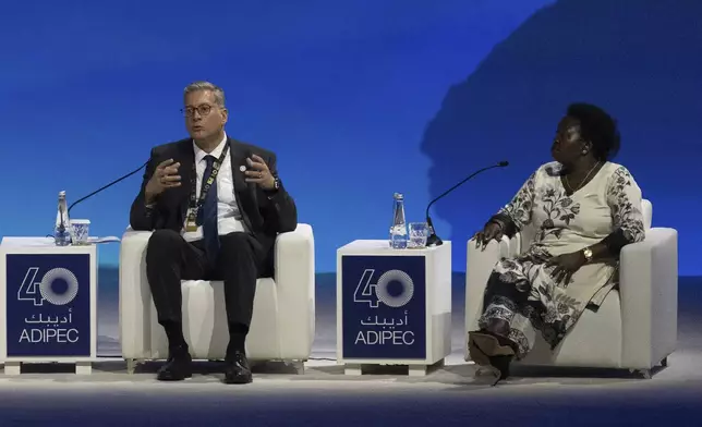 Egypt's Minister of Petroleum and Mineral Resources of Egypt Karim Badawi, left, talks in a panel as Uganda's Minister of Energy and Mineral Development Ruth Nankabirwa Ssentamu looks on during the the inaugural session of annual Abu Dhabi International Petroleum Exhibition and Conference (ADIPEC) in Abu Dhabi, United Arab Emirates, Monday, Nov. 4, 2024. (AP Photo/Altaf Qadri)