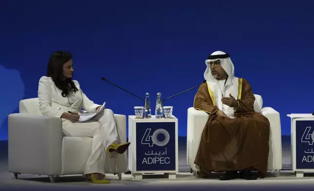 Moderator Hadley Gamble, left, looks on as UAE Minister of Energy and Infrastructure Suhail al-Mazrouei talks in a panel during the the inaugural session of annual Abu Dhabi International Petroleum Exhibition and Conference (ADIPEC) in Abu Dhabi, United Arab Emirates, Monday, Nov. 4, 2024. (AP Photo/Altaf Qadri)