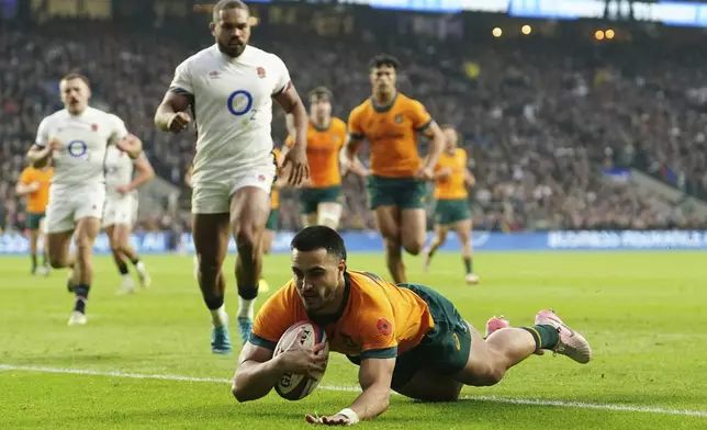 Australia's Tom Wright scores their side's first try during the Autumn Nations series rugby union match between England and Australia, at Twickenham stadium, London Saturday, Nov. 9, 2024. (David Davies/PA via AP)