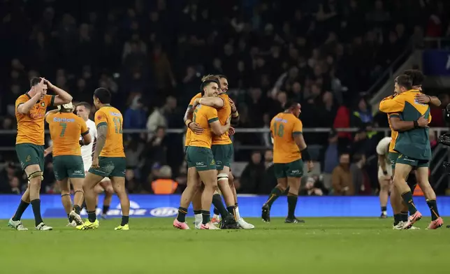 Australia's players celebrate after their teammate Max Jorgensen scored the winning try during the Autumn Nations series rugby union match between England and Australia, at Twickenham stadium, London Saturday, Nov. 9, 2024. (AP Photo/Ian Walton)