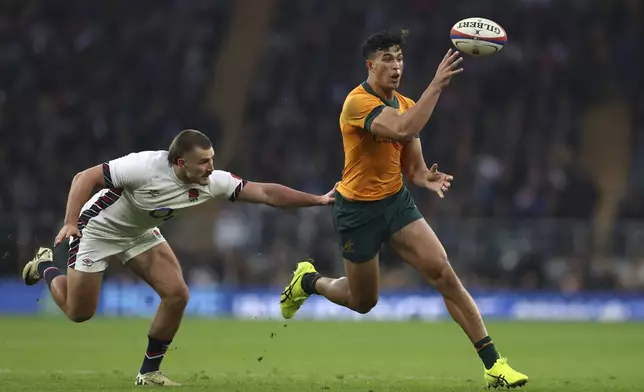 Australia's Joseph-Aukuso Suallii, right, is challenged by England's Ollie Sleightholme during the Autumn Nations series rugby union match between England and Australia, at Twickenham stadium, London Saturday, Nov. 9, 2024. (AP Photo/Ian Walton)