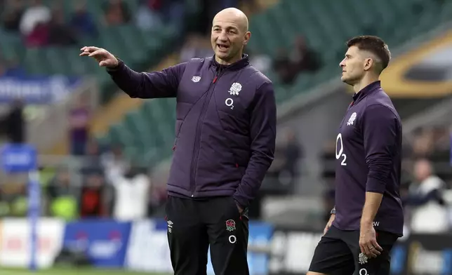 England's head coach Steve Borthwick, left, chats with a player as the team warm up for the Autumn Nations Series rugby match between England and New Zealand, at Twickenham stadium, in London Saturday, Nov. 2, 2024. (AP Photo/Ian Walton)