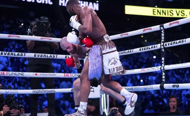 Jaron Ennis, right, gets Karen Chukhadzhian, left, into a corner during the fifth round of a IBF World Welterweight title bout Saturday, Nov. 9, 2024, in Philadelphia. Jaron Ennis retains his IBF World Welterweight title with a unanimous decision. (AP Photo/Chris Szagola)