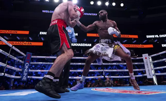 Jaron Ennis, right, throws a punch at Karen Chukhadzhian, left, during the 11th round of an IBF World Welterweight title bout Saturday, Nov. 9, 2024, in Philadelphia. Jaron Ennis retains his IBF World Welterweight title with a unanimous decision. (AP Photo/Chris Szagola)