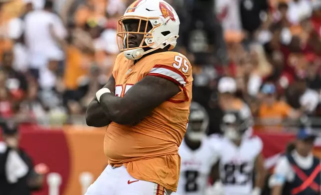 Tampa Bay Buccaneers defensive tackle C.J. Brewer (95) celebrates a sack on Atlanta Falcons quarterback Kirk Cousins during the second half of an NFL football game, Sunday, Oct. 27, 2024, in Tampa. (AP Photo/Jason Behnken)