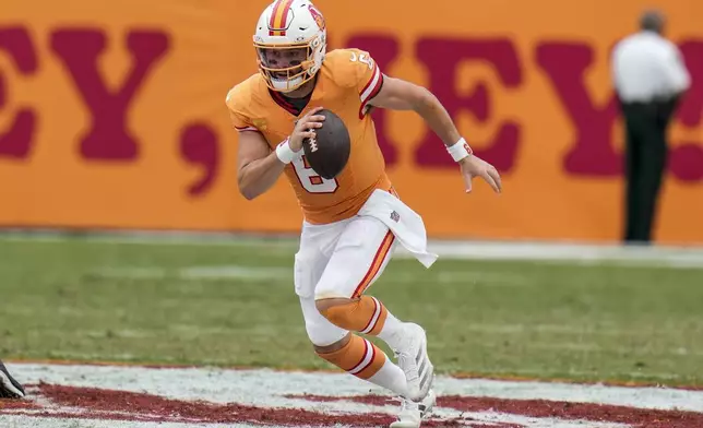 Tampa Bay Buccaneers quarterback Baker Mayfield (6) runs out of the pocket for a first down against the Atlanta Falcons during the second half of an NFL football game, Sunday, Oct. 27, 2024, in Tampa. (AP Photo/Chris O'Meara)