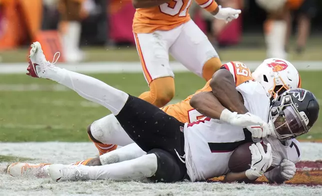 Tampa Bay Buccaneers cornerback Tyrek Funderburk (24) hits Atlanta Falcons running back Bijan Robinson (7) during the second half of an NFL football game, Sunday, Oct. 27, 2024, in Tampa. (AP Photo/Chris O'Meara)