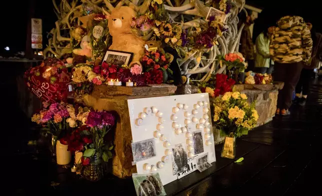 A shrine sits on the corner of town square to mourn the loss of grizzly bear No. 399 at a candlelight vigil in Jackson, Wyo., Saturday, Nov. 2, 2024. (AP Photo/Amber Baesler)