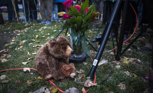 Teddy bears and flowers decorate a candlelight vigil in Jackson, Wyo., Saturday, Nov. 2, 2024. (AP Photo/Amber Baesler)