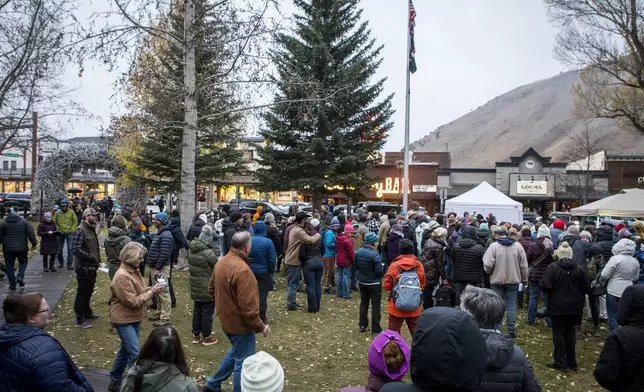Mourners gather to celebrate the life of grizzly bear No. 399 at a candlelight vigil in Jackson, Wyo. on Nov. 2, 2024. (AP Photo/Amber Baesler)