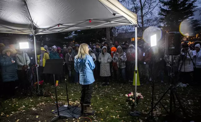 Speaker Tiffany Talbott addresses the crowd about the life and loss of grizzly bear No. 399 at a candlelight vigil in Jackson, Wyo., Saturday, Nov. 2, 2024. (AP Photo/Amber Baesler)