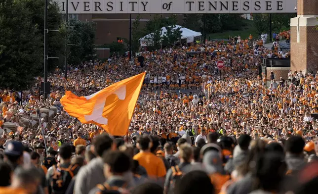 FILE - Tennessee fans gather outside Neyland Stadium before an NCAA college football game between Tennessee and Kent State in Knoxville, Tenn., Sept. 14, 2024. (AP Photo/George Walker IV, File)