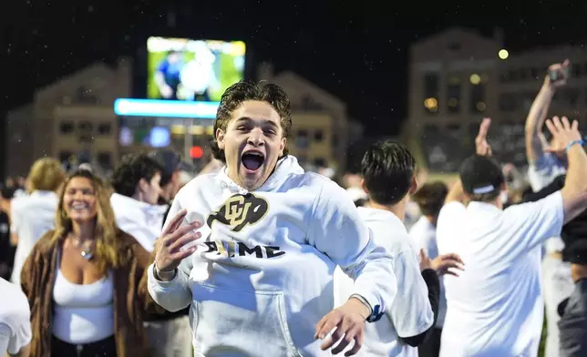 FILE - Colorado fans storm the playing field after Colorado's overtime victory over Baylor in an NCAA college football game Saturday, Sept. 21, 2024, in Boulder, Colo. (AP Photo/David Zalubowski, File)