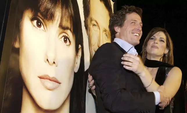 FILE - Actors Hugh Grant, left, and Sandra Bullock appear at a screening of their film, "Two Weeks Notice," in the Westwood section of Los Angeles, on Dec. 18, 2002. (AP Photo/Chris Weeks, File)