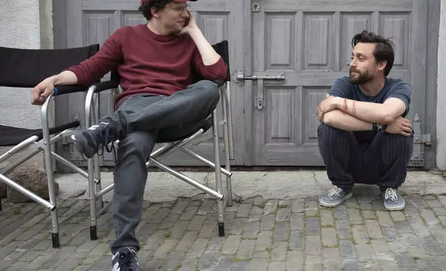 This image released by Searchlight Pictures shows Kieran Culkin, right, and Jesse Eisenberg on the set of "A Real Pain." (Searchlight Pictures via AP)