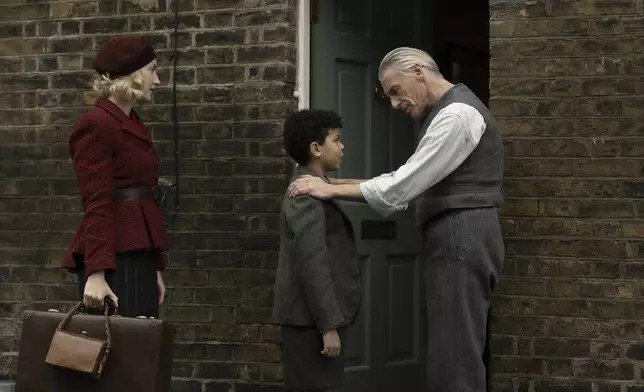 This image released by Apple TV+ shows Saoirse Ronan, from left, Elliott Heffernan, and Paul Weller in a scene from "Blitz." (Apple TV+ via AP)