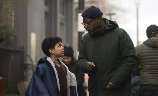 This image released by Apple TV+ shows Elliott Heffernan, left, and filmmaker Steve McQueen on the set of "Blitz." (Apple TV+ via AP)