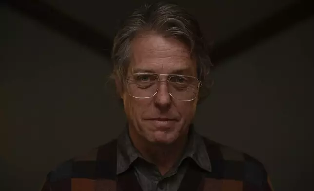 This image released by A24 shows Hugh Grant in a scene from "Heretic." (Kimberley French/A24 via AP)