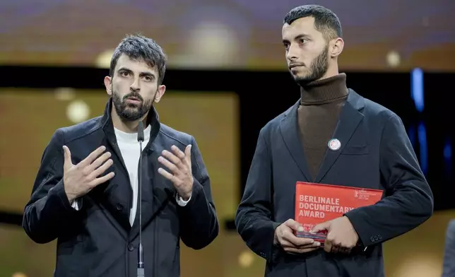 FILE - Palestinian Basel Adra, right, and Israeli Yuval Abraham receive the documentary award for "No Other Land" at the International Film Festival, Berlinale, in Berlin, Saturday, Feb. 24, 2024. (AP Photo/Markus Schreiber, File)