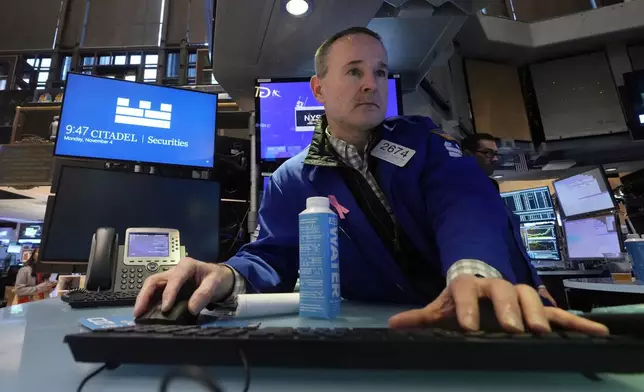 Specialist Stephen Naughton work at his post on the floor of the New York Stock Exchange, Monday, Nov. 4, 2024. (AP Photo/Richard Drew)